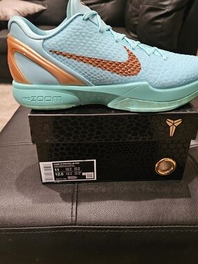 Nike men's Light Blue Basketball Shoes with Orange Accents